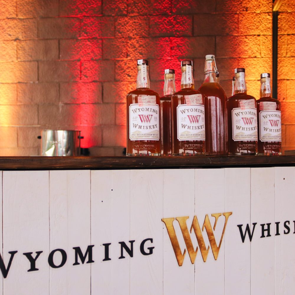 Image of Wyoming Whiskey bottles on a branded bar